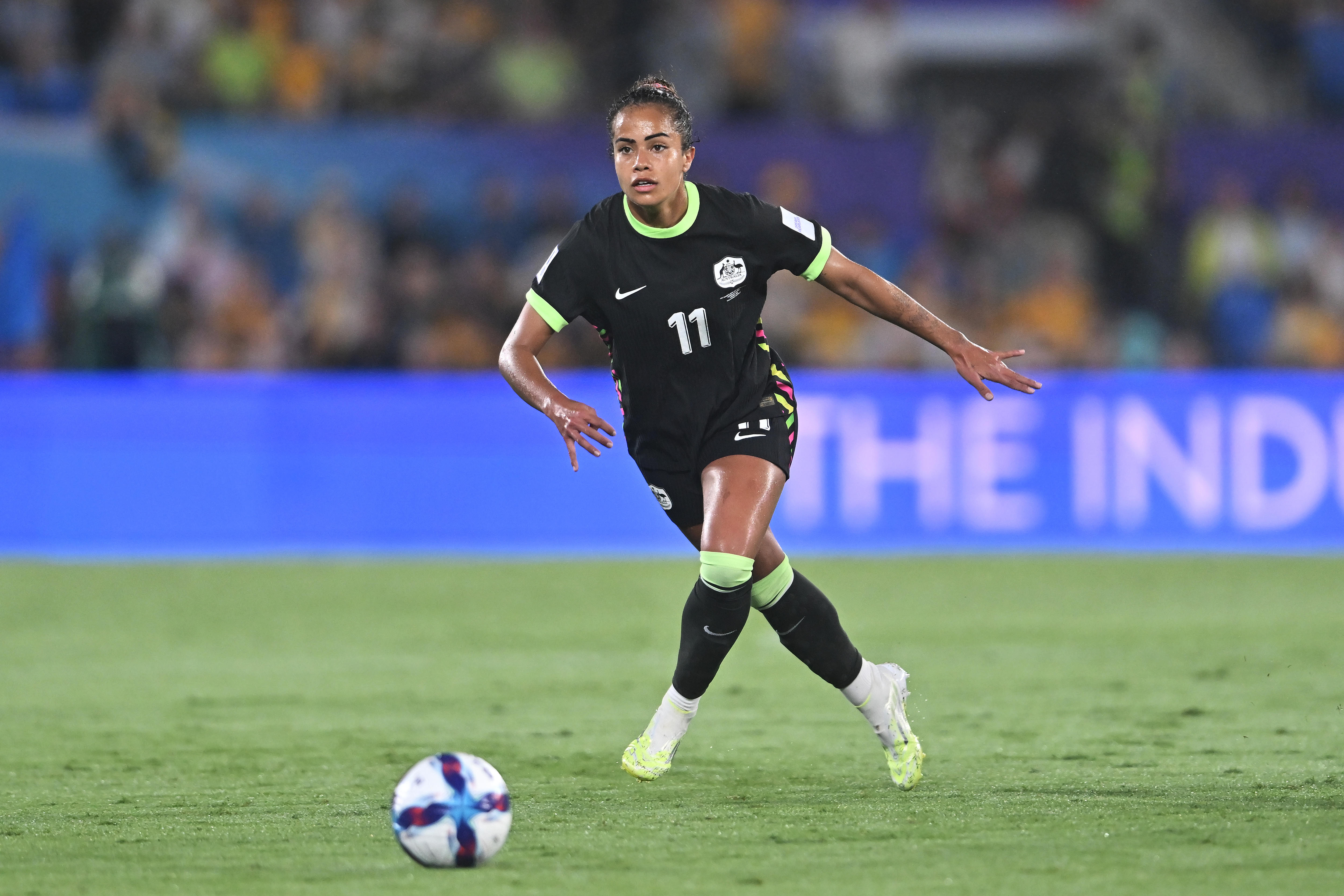 A jogadora do Matildas, Mary Fowler, corre com a bola à sua frente durante um jogo