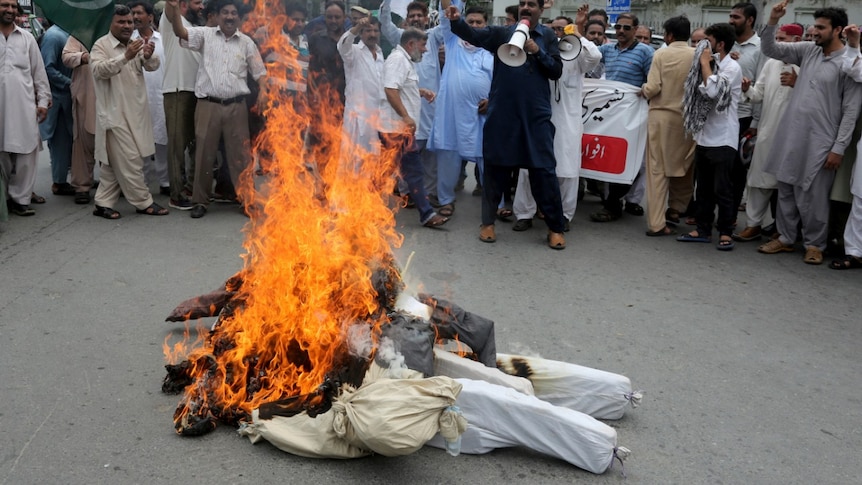 Pakistani clerks shout anti India slogans after burning effigies of Indian Prime Minster Narendra Modi