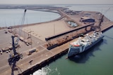 An aerial view of a ship anchored at a wharf part of the Darwin Port.