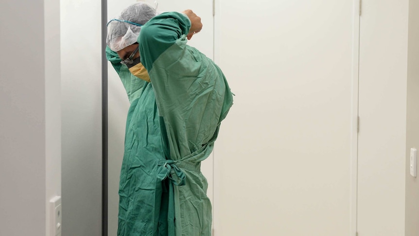 A doctor prepares for surgery in hospital