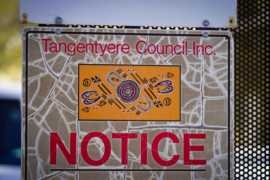 A sign with Aboriginal artwork with reads 'Tangentyere Council NOTICE'