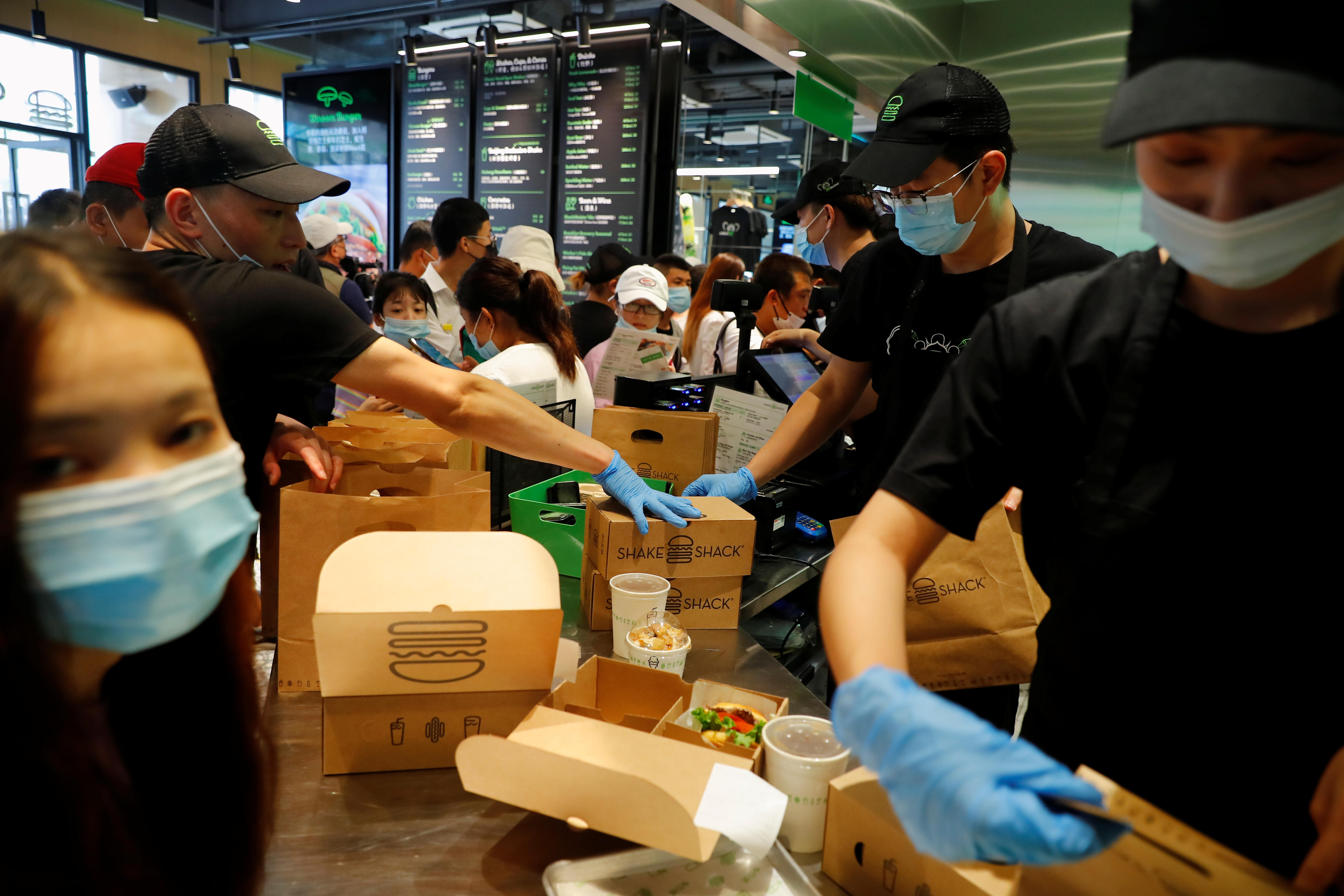 People order food on the opening day of the first Beijing outlet of the U.S. fast food chain Shake Shack.