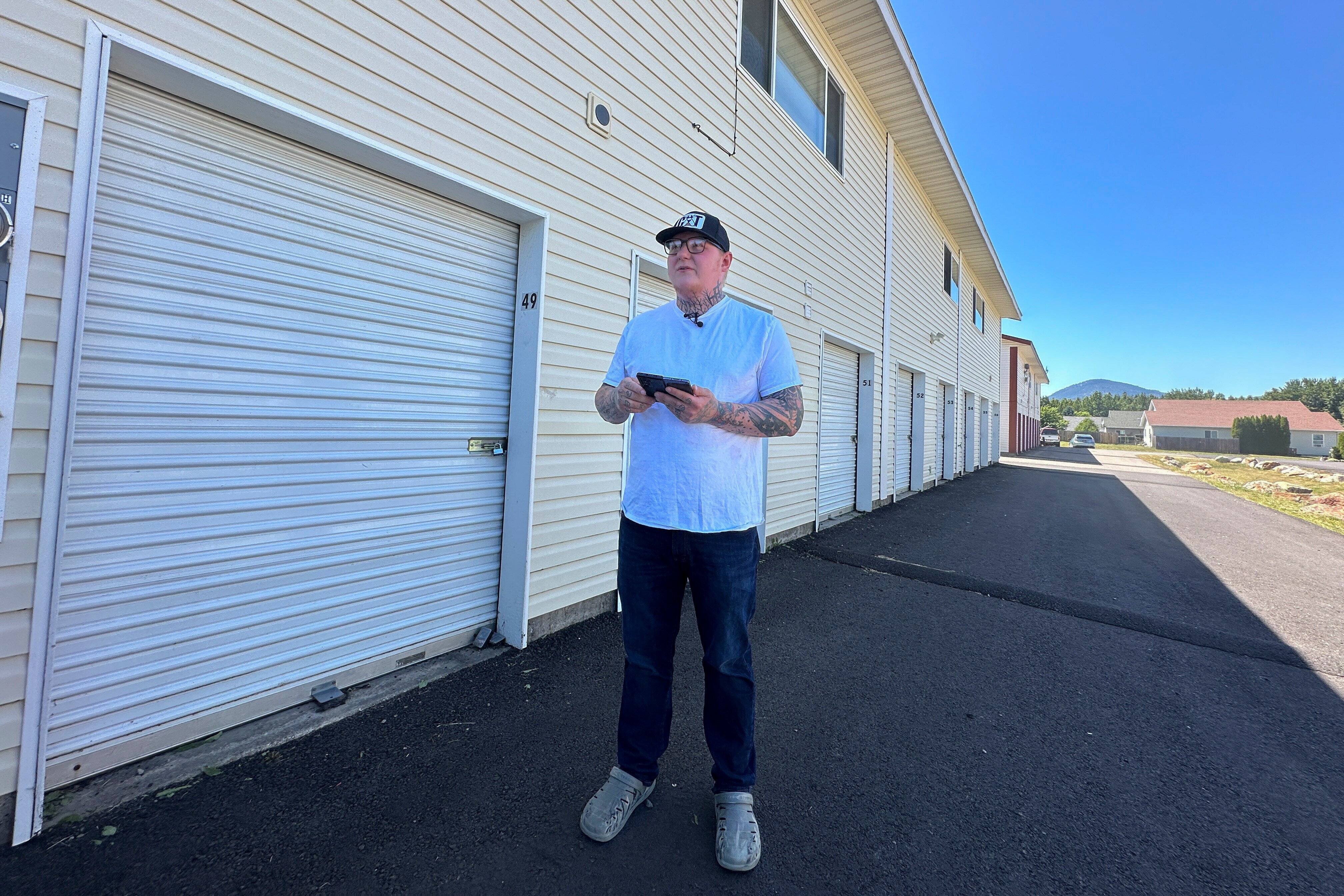 A man is outside an apartment block