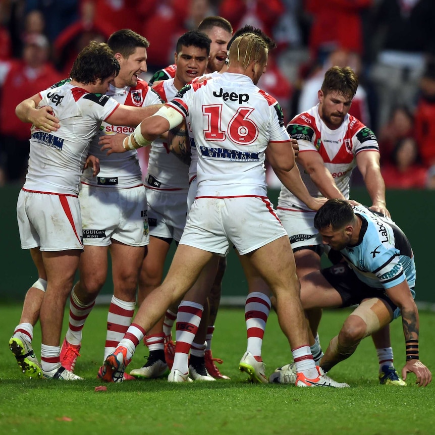 The Dragons celebrate a try against the Sharks