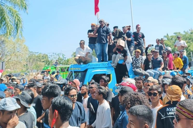 People protest on a car and on the street in Indonesia