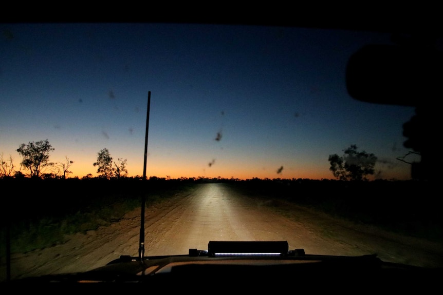 Driving along a dirt road at dawn