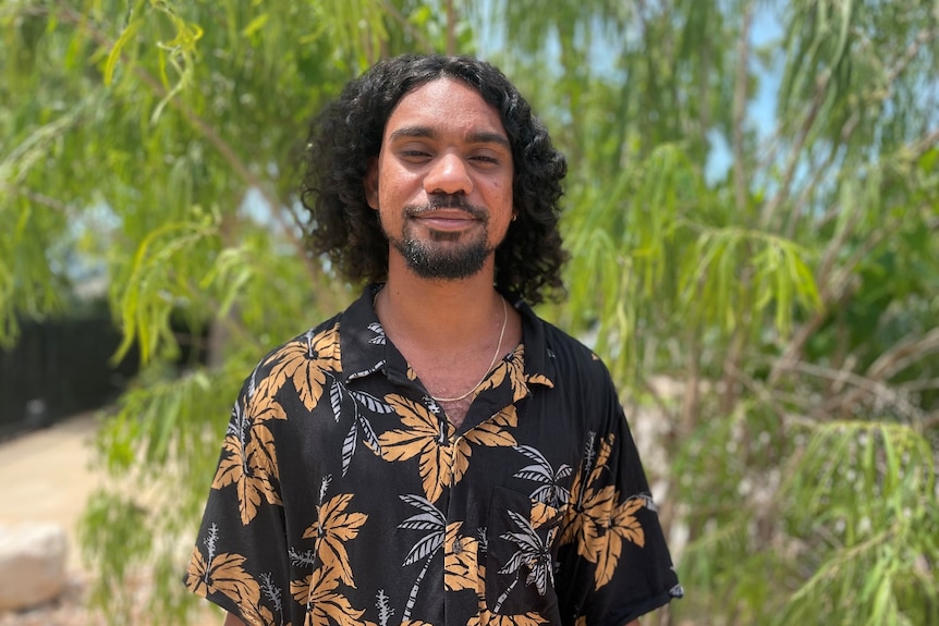 A young Indigenous man, smiling.