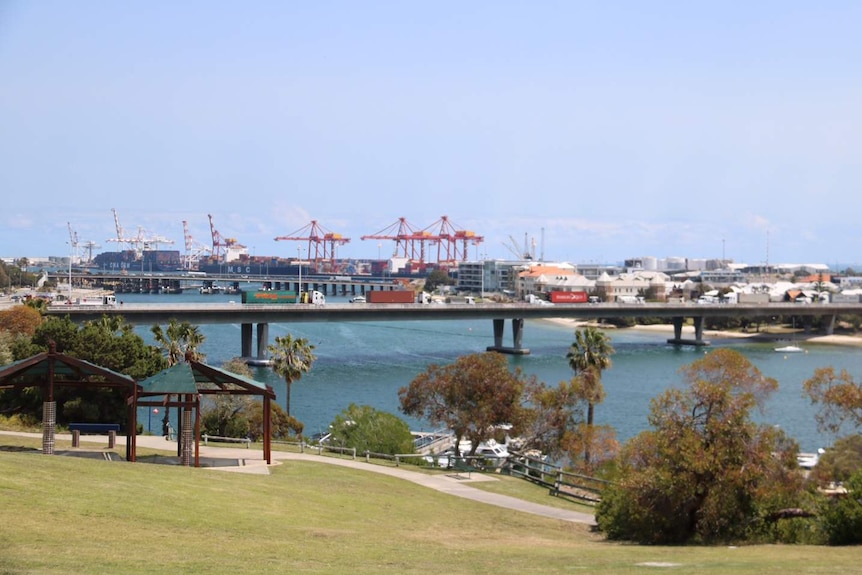 A wide shot of traffic banked up on Stirling Highway Bridge near Fremantle with the port in the background.