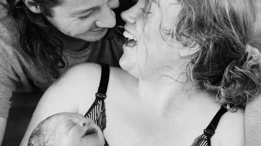 a couple embrace their new baby moments after giving birth