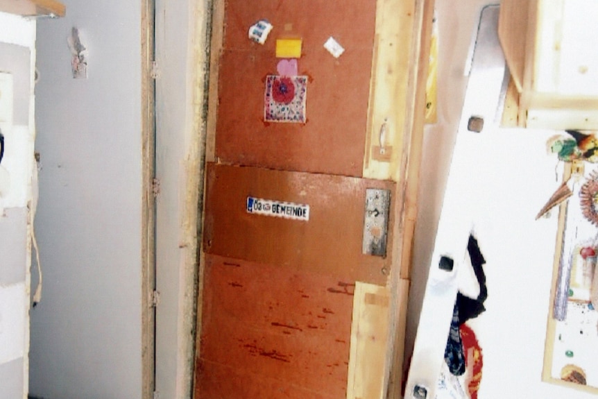 The corner of a basement room, showing rough, unfinished walls.