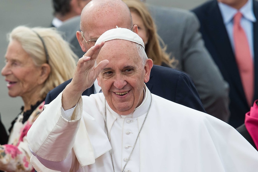 Pope Francis waves.