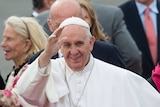 Pope Francis waves.