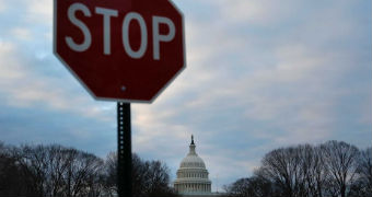 A stop sign is seen in front of the capitol building