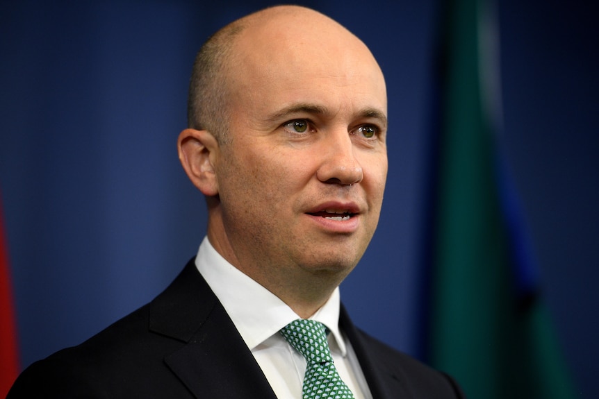 A man speaks at a lectern