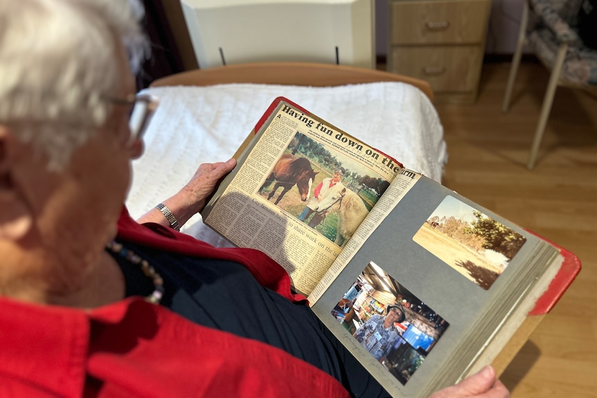older lady looking at a photo album 