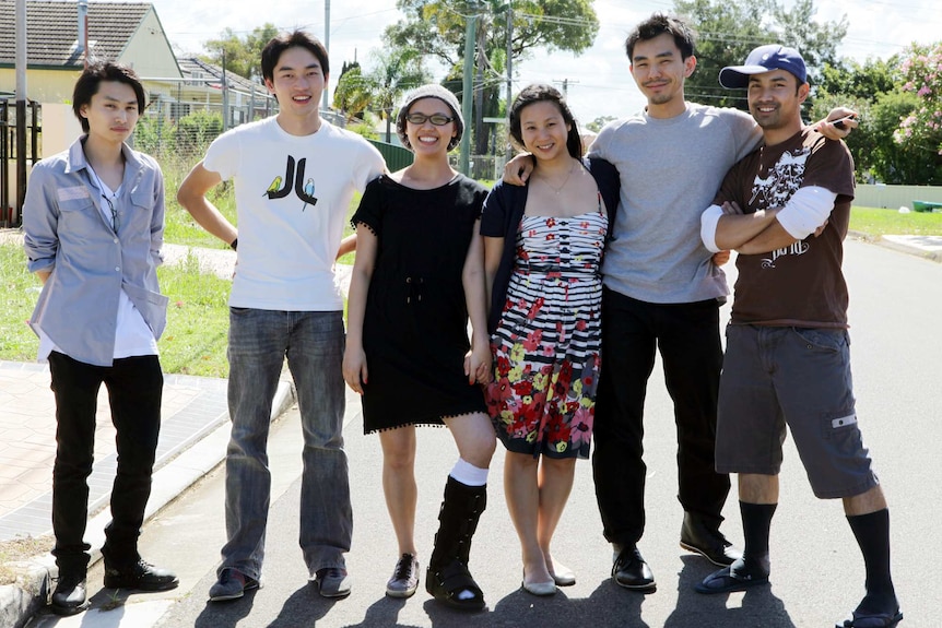 Tina with friends wearing her moonboot during treatment