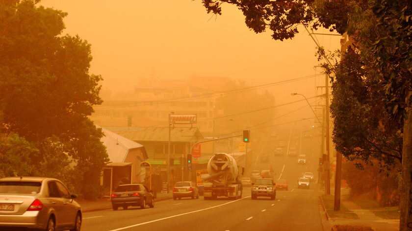 Cars drive down Milton Road during the dust storm in Brisbane.