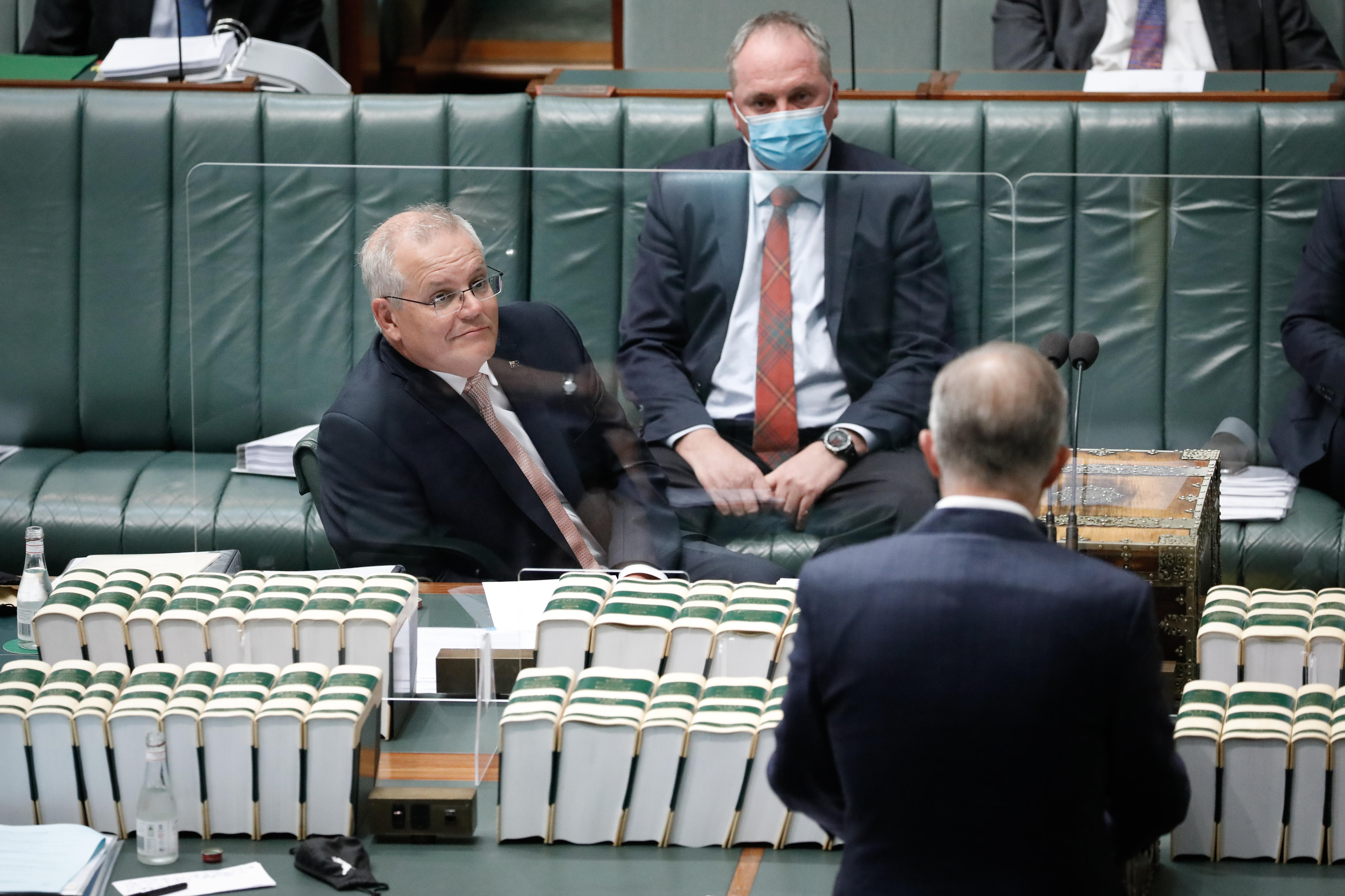 Scott Morrison and Barnaby Joyce look across to Anthony Albanese, who is speaking in the House of Represenatives