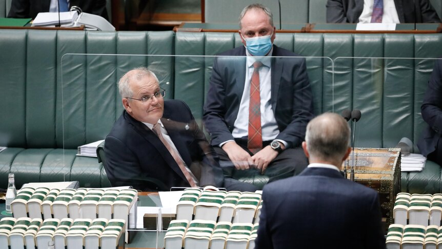 Scott Morrison and Barnaby Joyce look across to Anthony Albanese, who is speaking in the House of Represenatives