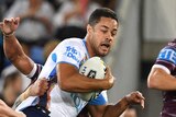 Jarryd Hayne carries the ball as he is tackled by Manly players