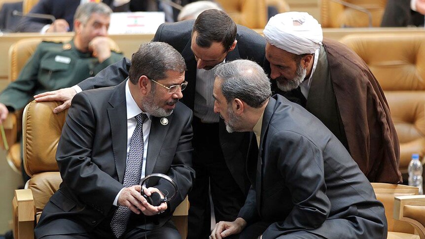 Mohammed Morsi speaks to Iranian officials during Non-Aligned Movement summit in Tehran