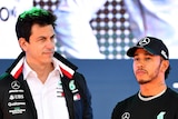 F1 driver Lewis Hamilton and Mercedes boss Toto Wolff standing side by side