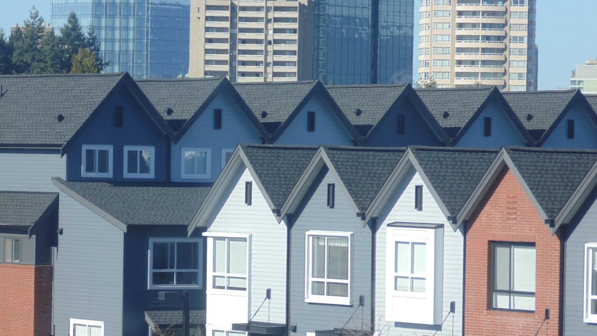 Houses in Vancouver, Canada, with the city skyline in the background.
