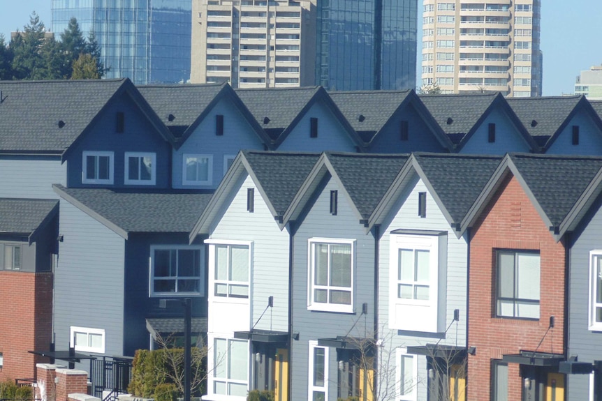 Houses in Vancouver, Canada, with the city skyline in the background.