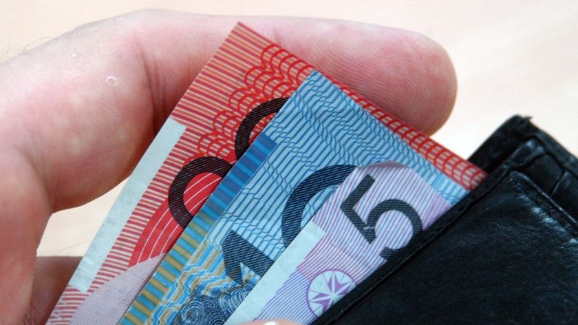 man taking Australian notes out of a wallet