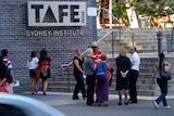 Teachers stand outside TAFE in Sydney
