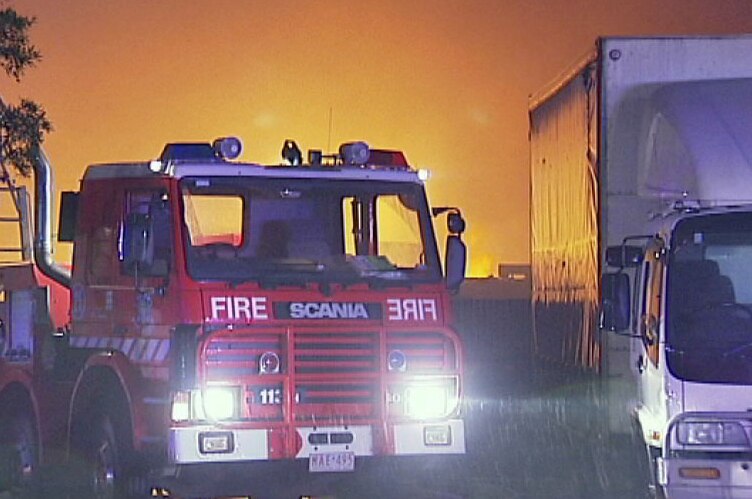 MFB truck parked in front of a wall of orange fire at Keysborough.