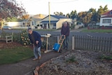 An elderly Tasmanian couple cart water to their house in Tasmania's north-east