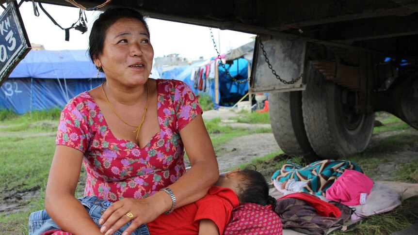 Nima Sherpa and her child shelter under a truck