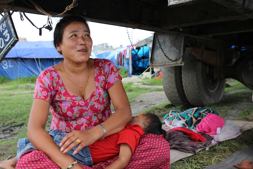 Nima Sherpa and her child shelter under a truck