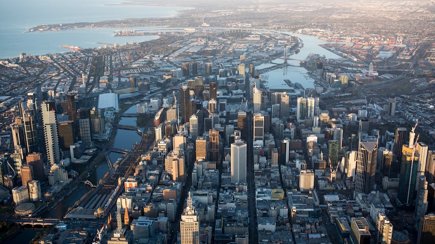 Early morning light hits the skyscrapers of Melbourne's CBD, as seen from above.