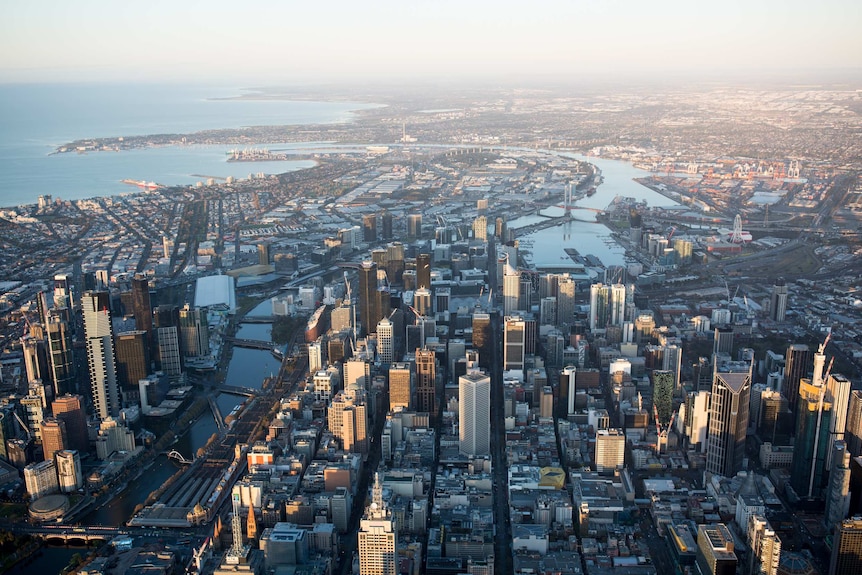 Early morning light hits the skyscrapers of Melbourne's CBD, as seen from above.