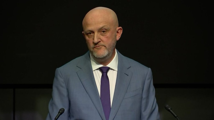 Man stands at a podium giving a speech