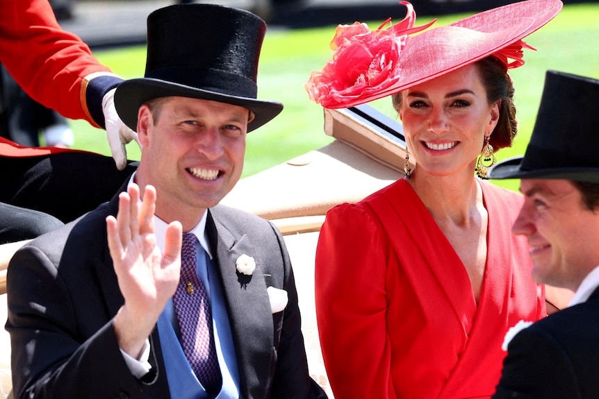 Prince William wearing a top hat smiles and waves next to his wife Catherine wearing a pink hat and dress.