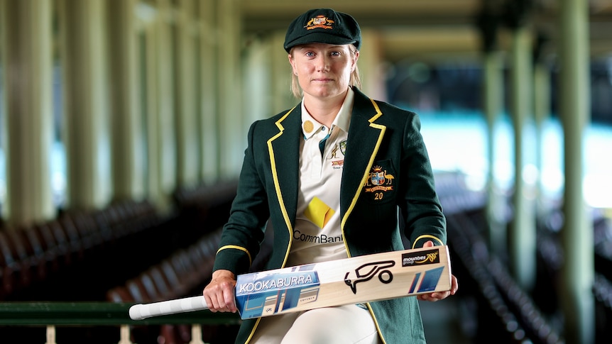 Alyssa Healy sits in the old members stand at the SCG with her captain's blazer and baggy green on