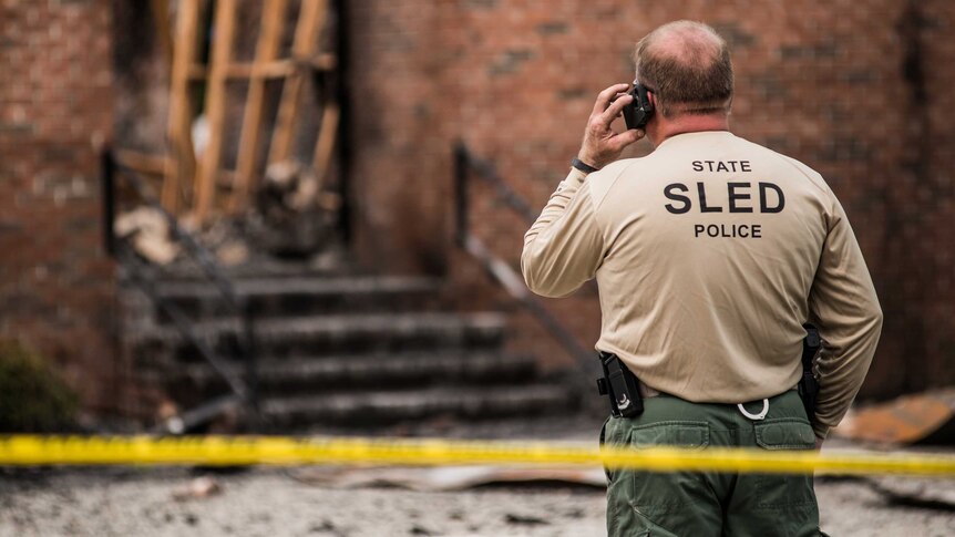 Police investigate the burned ruins of the Mt. Zion AME Church in South Carolina.