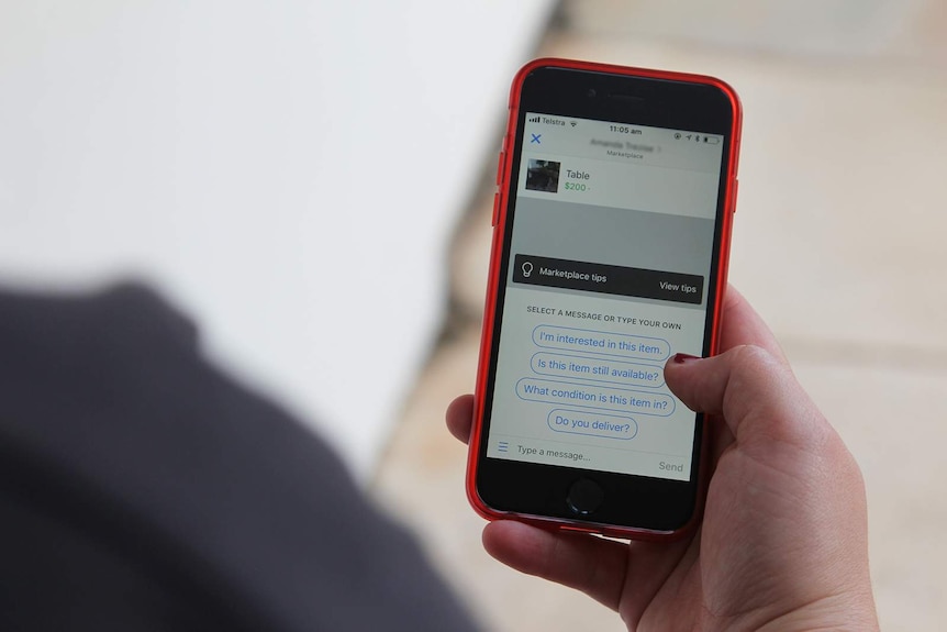 A photo of a phone being used to buy a table on Facebook.