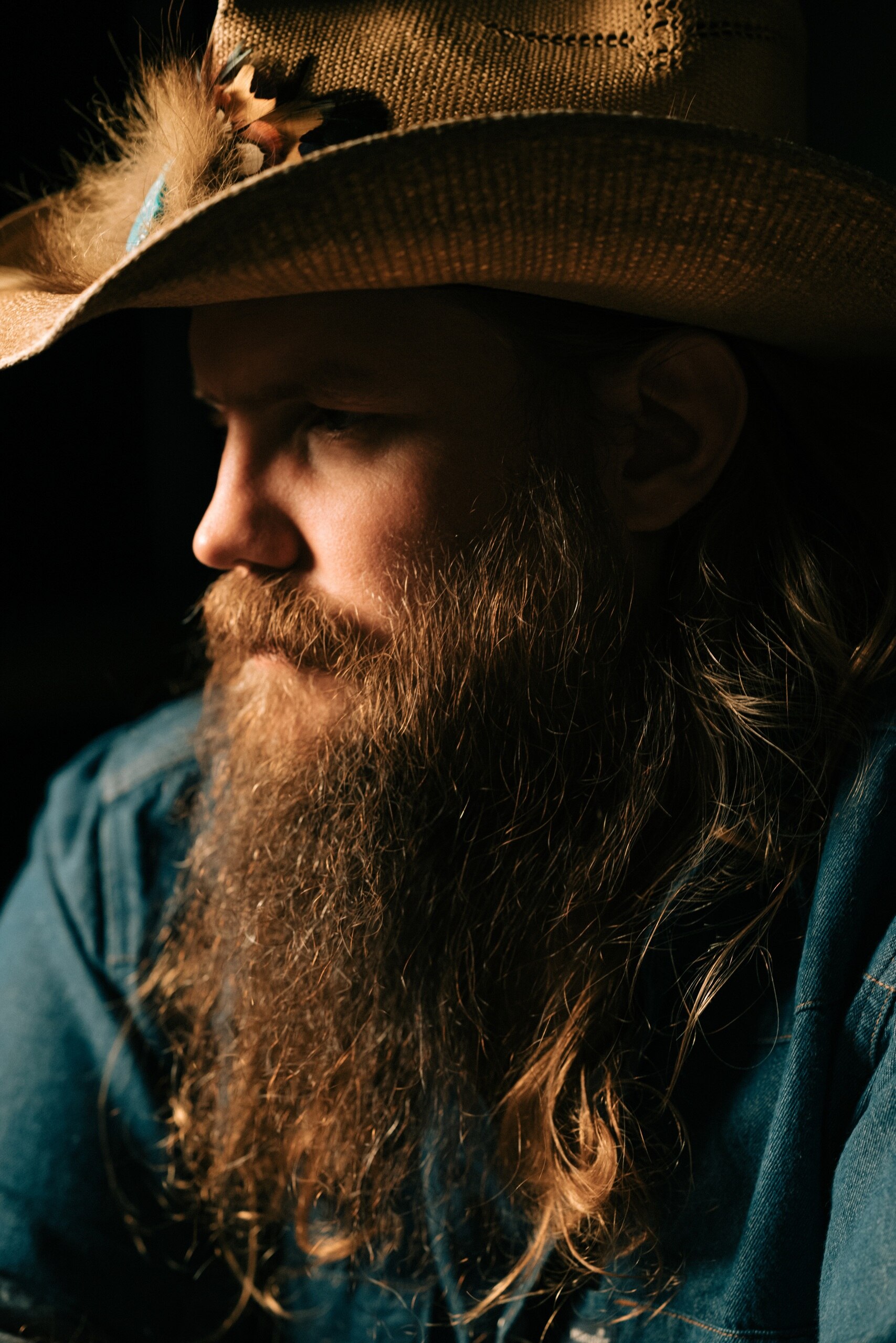 Press photo of Chris Stapleton with a long beard and cowboy hat