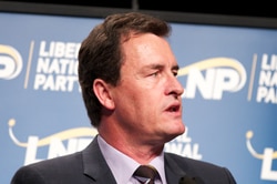 Gary Spence speaks at a lectern at an LNP conference in Queensland.