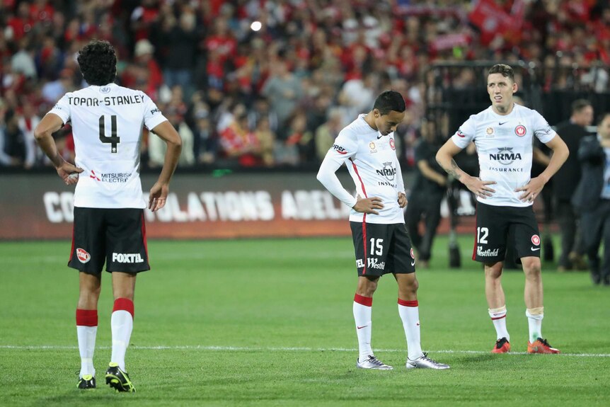 Dejected Wanderers players after losing A-League grand final