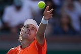 Alex de Minaur throws the ball up to serve against Alexander Zverev at Indian Wells.