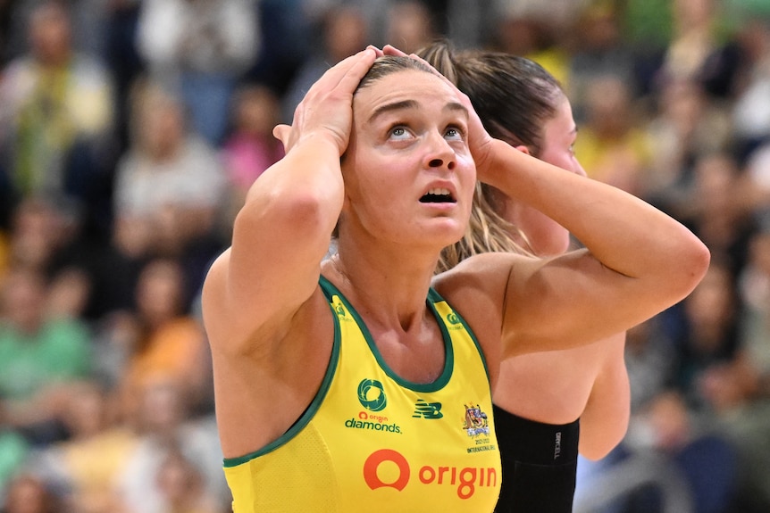 Liz Watson puts her hands on her head and looks up at the scoreboard with a worried expression