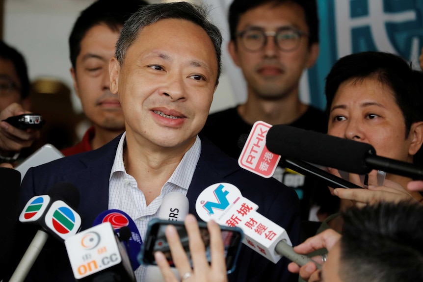 Benny Tai speaks to the media as he leaves the high court after being released on bail in Hong Kong