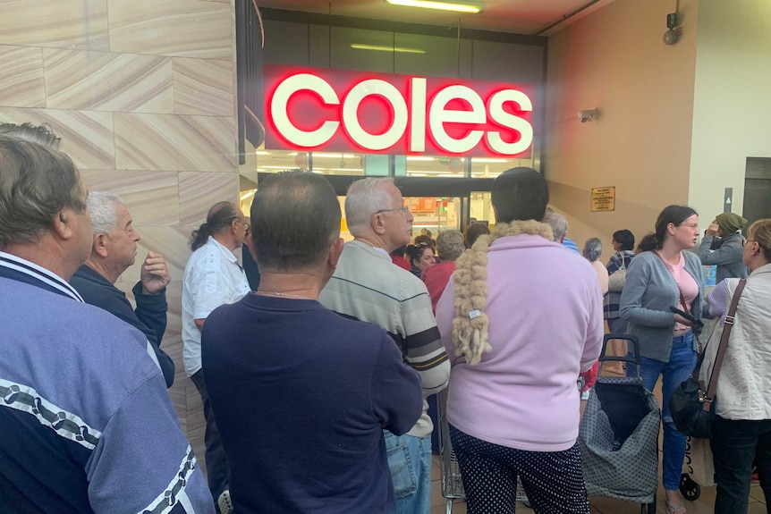 A large queue outside a Coles supermarket