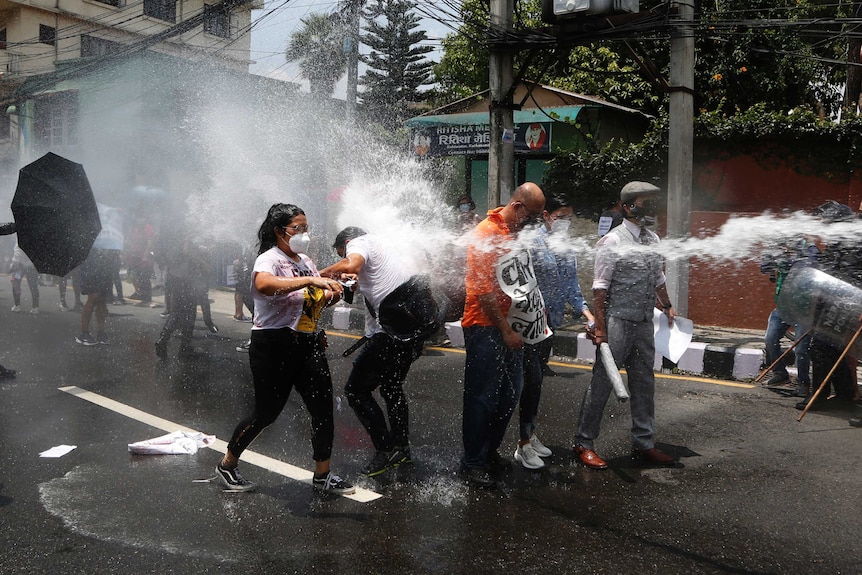 Nepalese police use water cannon to disperse youth who were protesting on the road leading to the prime minister's residence.