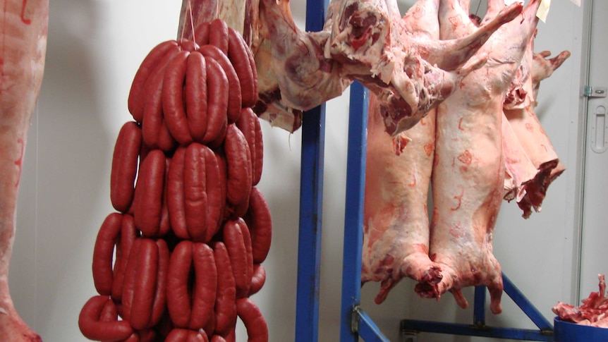 red meat hanging in butchery